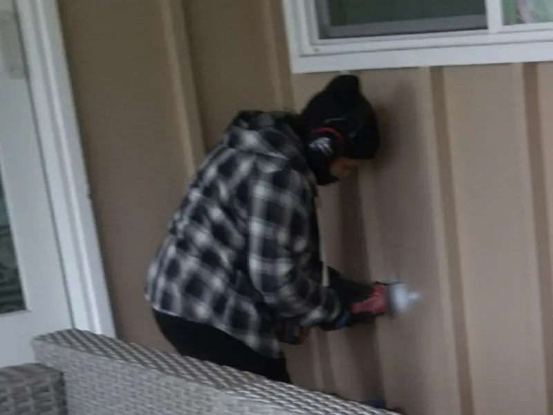 Professional electrician installing an exterior outlet in Warsaw