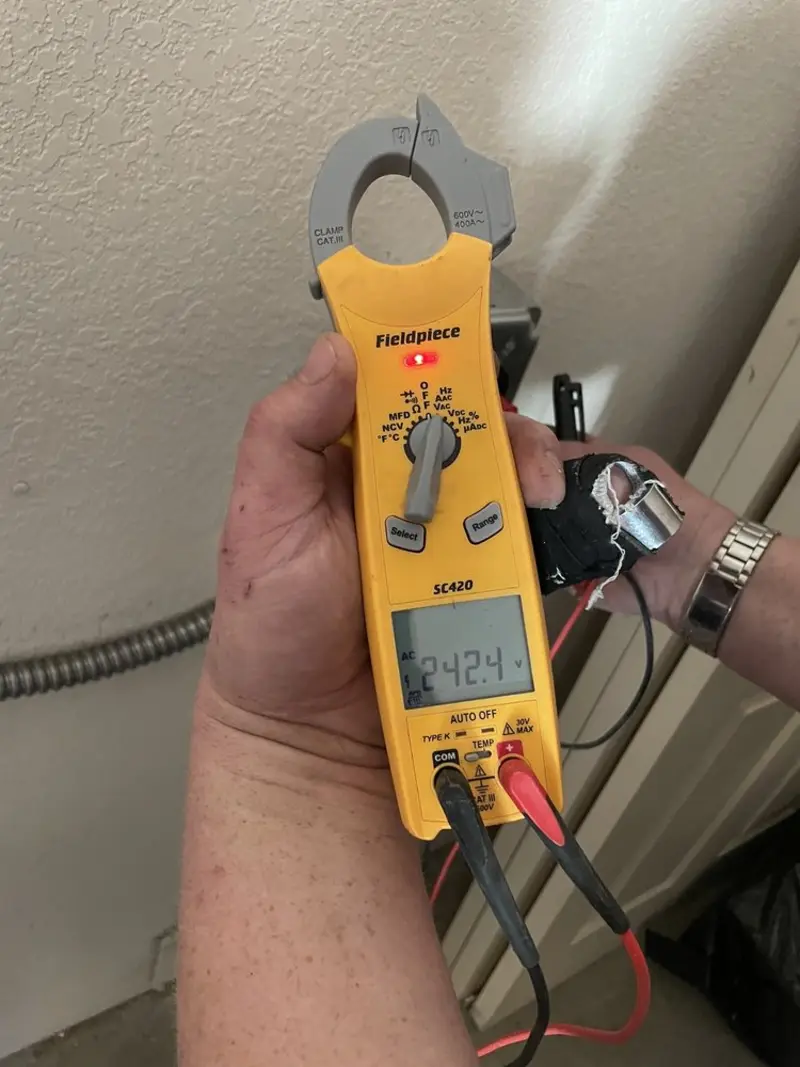 Voltage testing with clamp meter during Electrical Installation Services in Warsaw